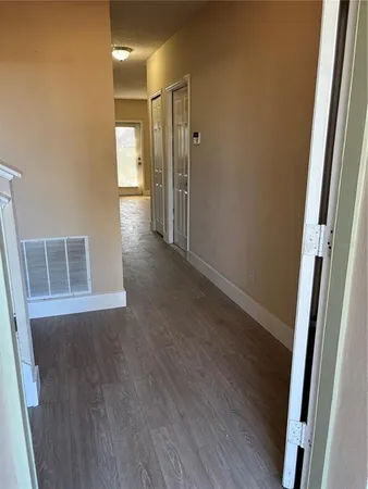 a view of hallway with wooden floor