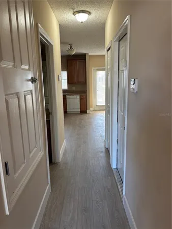 a view of a hallway with wooden floor