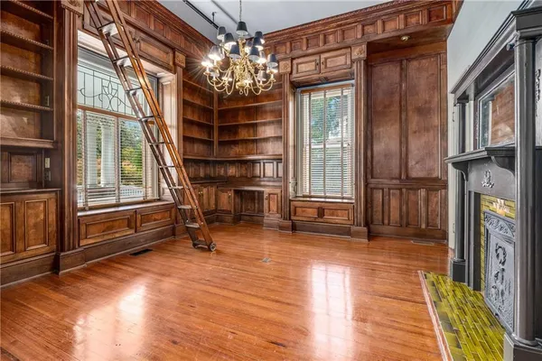 a view of a room with wooden floor and fireplace