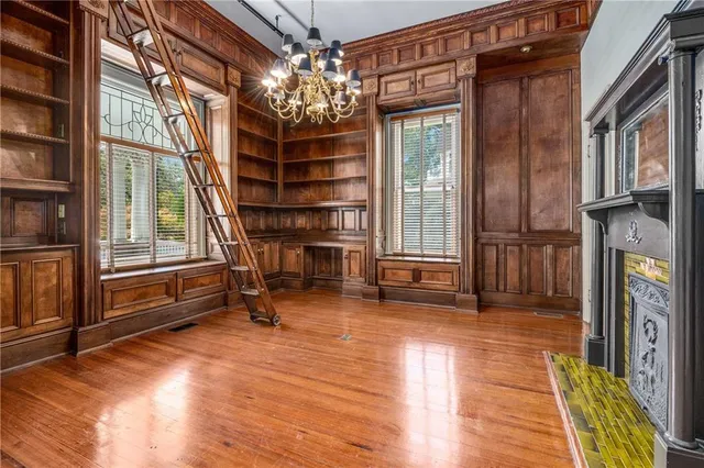 a view of a room with wooden floor and fireplace