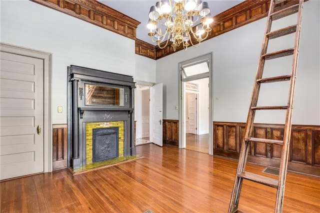 a view of an empty room with a window and fireplace