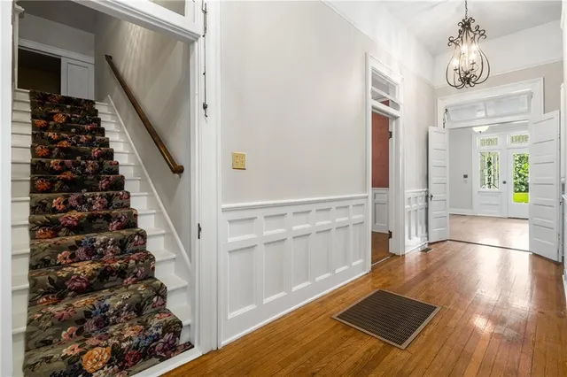 a view of a hallway to a bedroom and front door