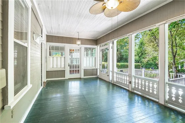 an aerial view of residential houses with outdoor space and trees