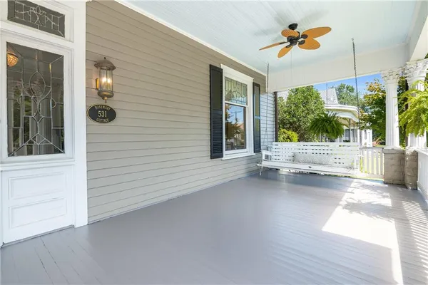 an empty room with wooden floor a fireplace and a window