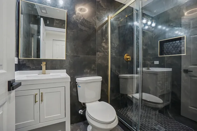 a bathroom with a toilet a sink and mirror