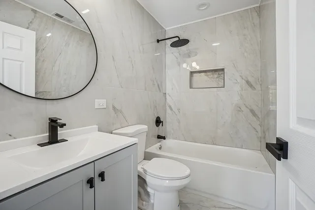 a bathroom with a sink a toilet and bathtub