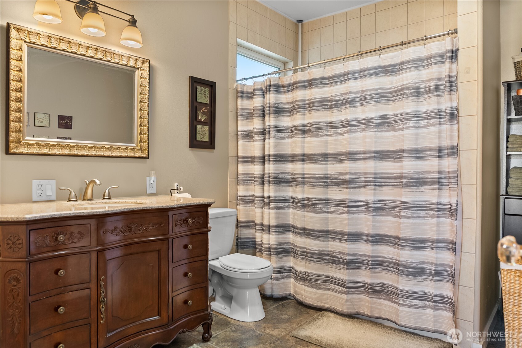 72 Boundary Point Road Oroville, WA 98844 - Photo 18 of 40 a bathroom with a sink a toilet and shower curtain