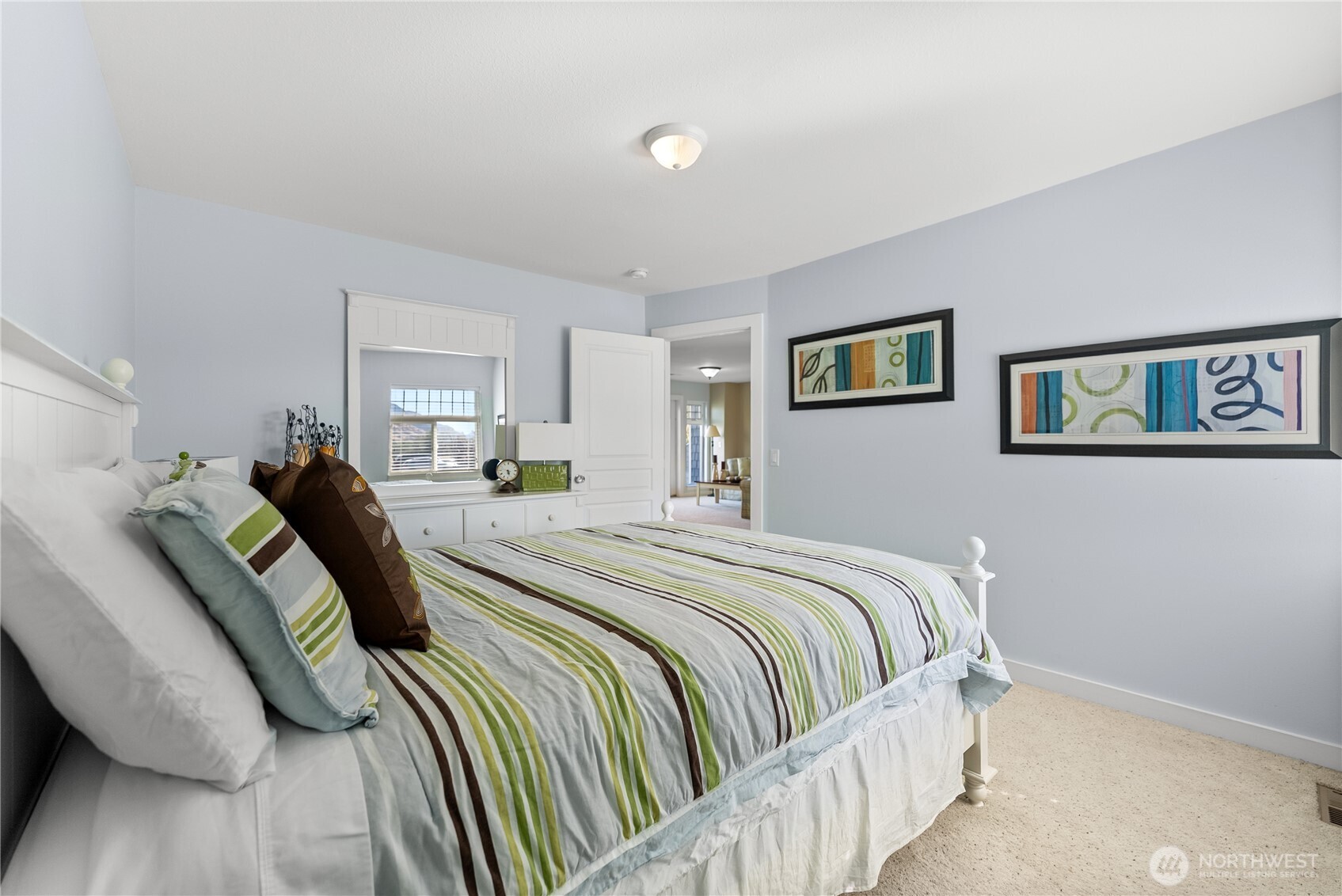 72 Boundary Point Road Oroville, WA 98844 - Photo 22 of 40 a bed room with a bed and a painting