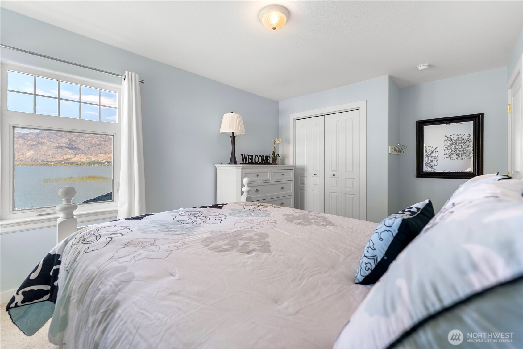 72 Boundary Point Road Oroville, WA 98844 - Photo 26 of 40 a bedroom with a bed and a large window