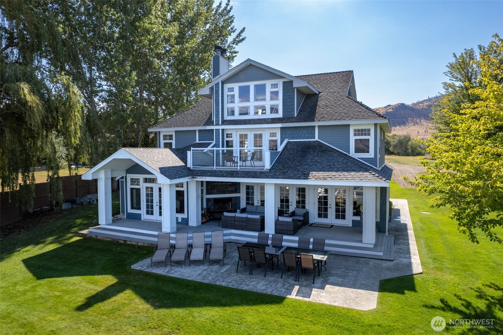 72 Boundary Point Road Oroville, WA 98844 - Photo 3 of 40 a front view of a house with a yard table and chairs