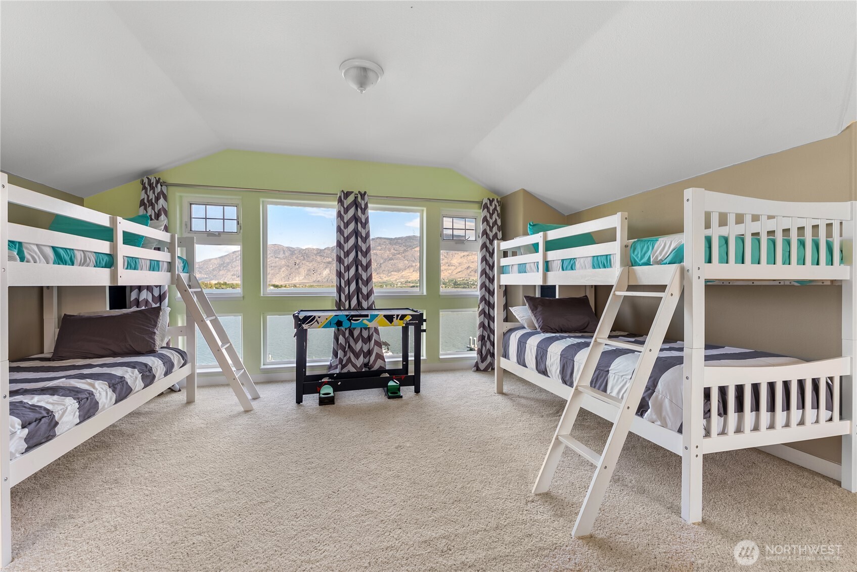 72 Boundary Point Road Oroville, WA 98844 - Photo 32 of 40 a living room with furniture a flat screen tv and a large window