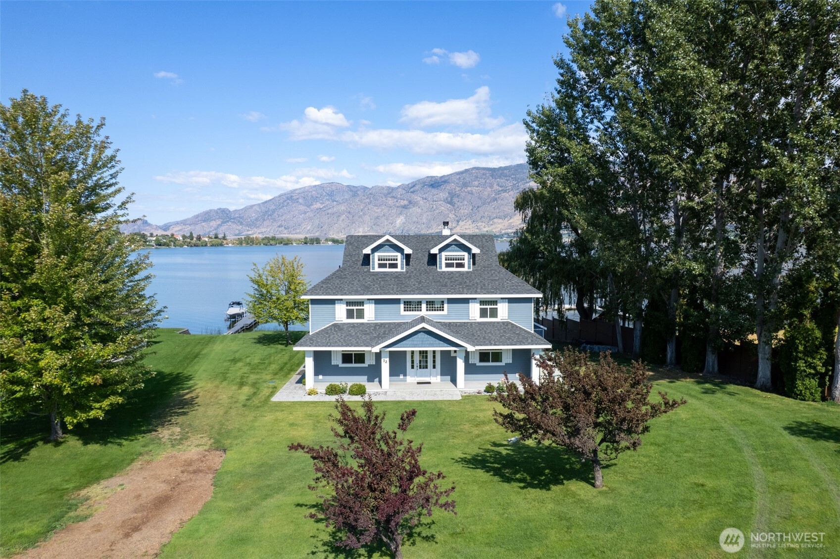 72 Boundary Point Road Oroville, WA 98844 - Photo 38 of 40 a front view of a house with a garden