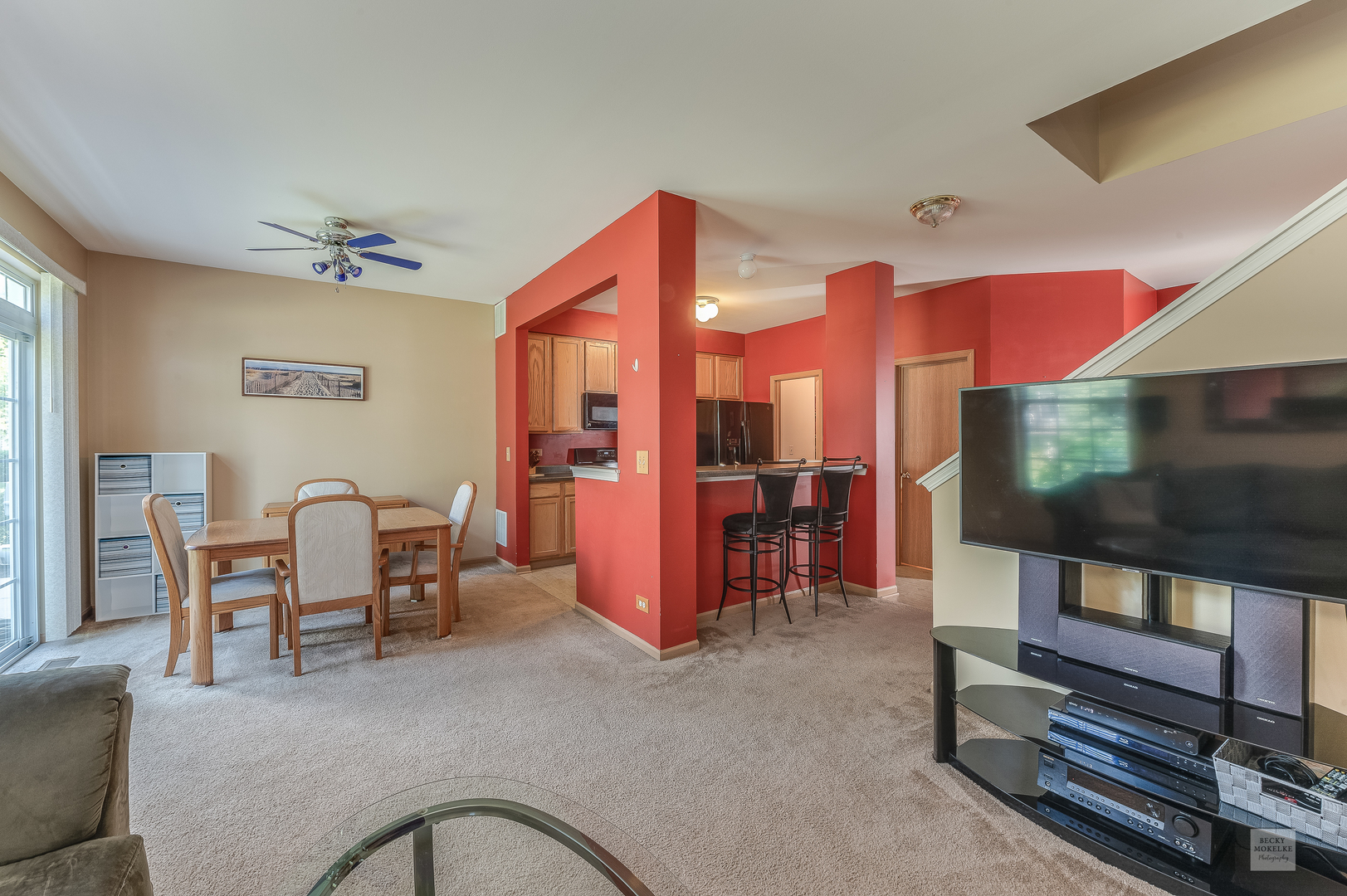 357 Grape Vine Trail Oswego, IL 60543 - Photo 9 of 27 a living room with furniture a flat screen tv and kitchen view