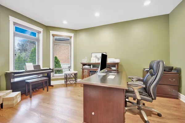 a workspace with furniture and a wooden floor