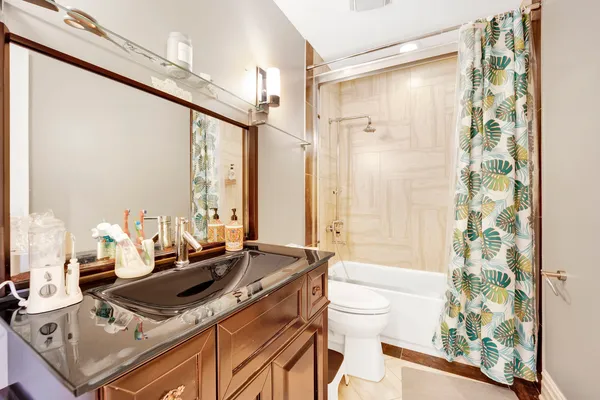 a bedroom with a bed and a painting on the wall