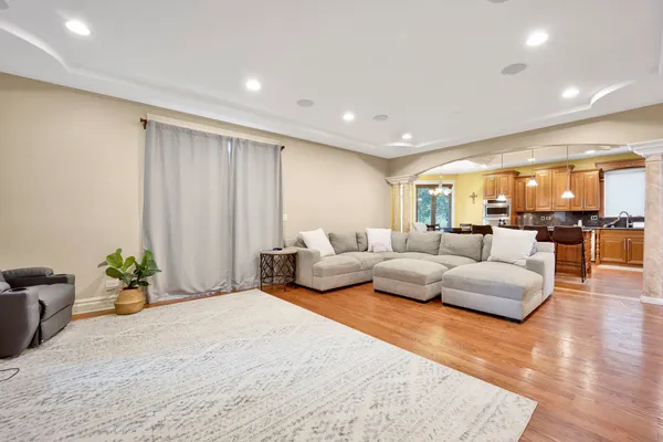 a spacious bedroom with a bed a couch and a potted plant