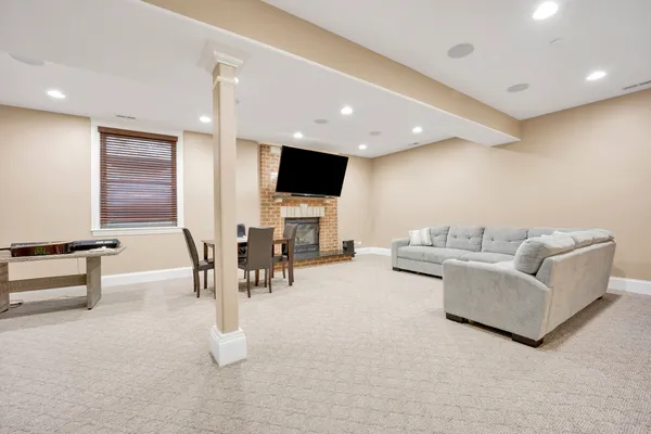 a living room with furniture and a dining table with projector the kitchen