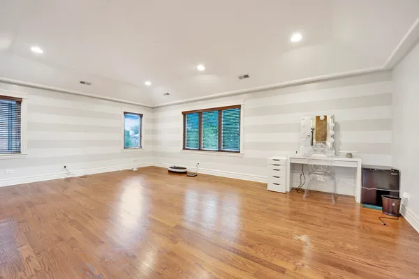 a view of empty room with kitchen and window