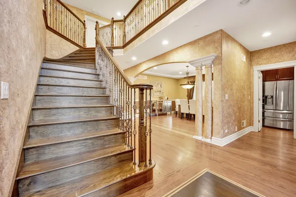 a view of entryway and hall with wooden floor