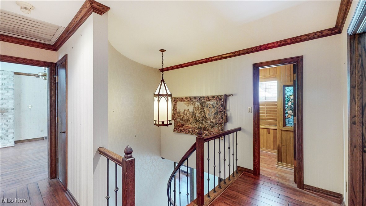 1091 Sand Run Road Akron, OH 44313 - Photo 16 of 26 The upstairs landing features wood floors, large pendant light and crown molding.