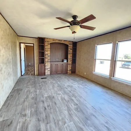 a view of livingroom with hardwood floor and ceiling fan