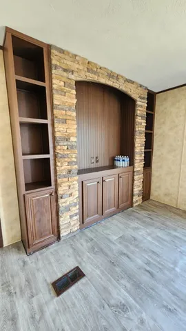 a view of a kitchen with cabinets and wooden floor