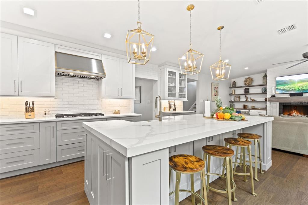 640 Arjay Way Winter Park, FL 32789 - Photo 13 of 46 a kitchen with stainless steel appliances granite countertop a sink a stove and a wooden floors