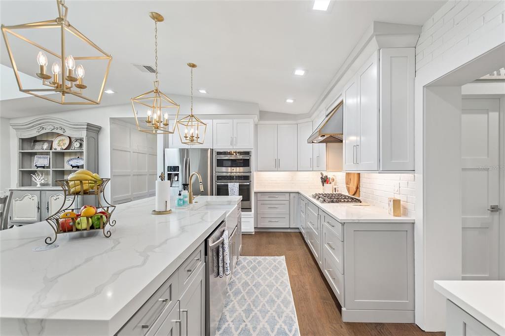 640 Arjay Way Winter Park, FL 32789 - Photo 15 of 46 a kitchen with counter top space a sink stainless steel appliances and cabinets