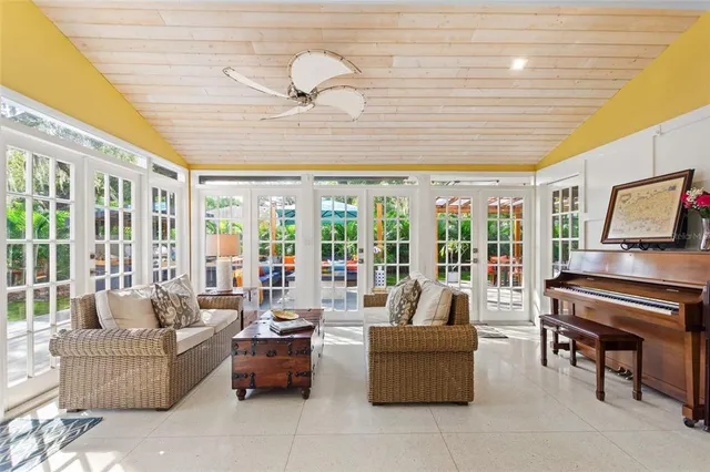 a living room with furniture and large windows