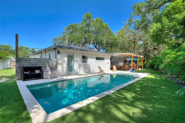 a view of house with swimming pool yard and outdoor seating