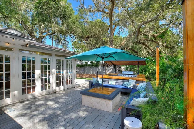 a view of pool with table and chairs under an umbrella