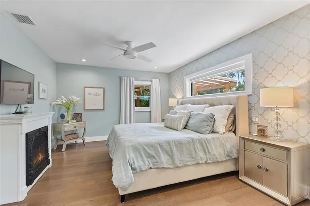 a bedroom with a large bed and a fireplace