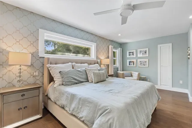 a bedroom with a large bed and a window