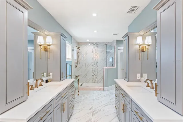 a bathroom with a double vanity sink a large mirror and a shower