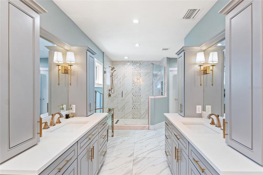 640 Arjay Way Winter Park, FL 32789 - Photo 26 of 46 a bathroom with a double vanity sink a large mirror and a shower