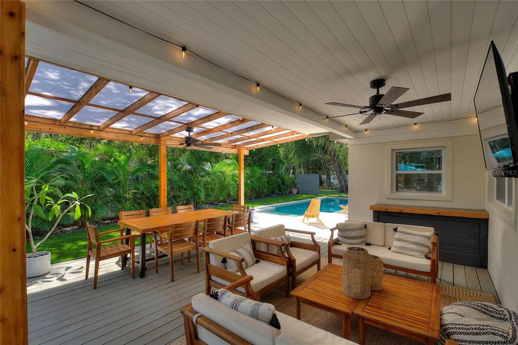 640 Arjay Way Winter Park, FL 32789 - Photo 30 of 46 a living room with patio furniture and a floor to ceiling window