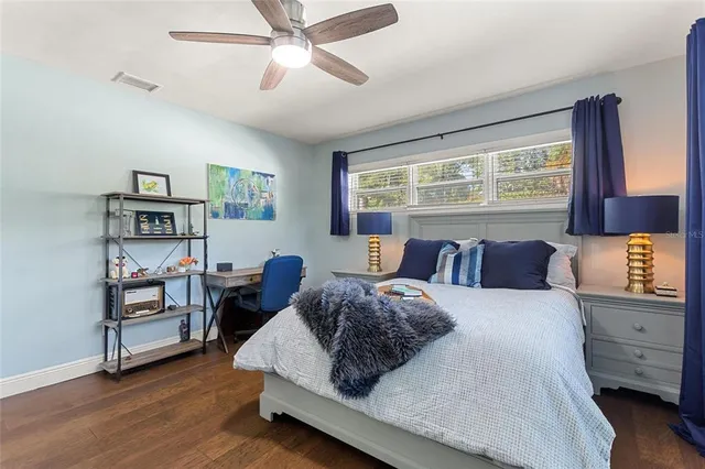 a large bedroom with a bed and furniture