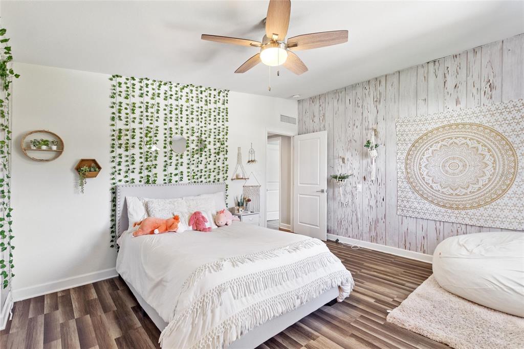 640 Arjay Way Winter Park, FL 32789 - Photo 38 of 46 a bedroom with a bed and a chandelier