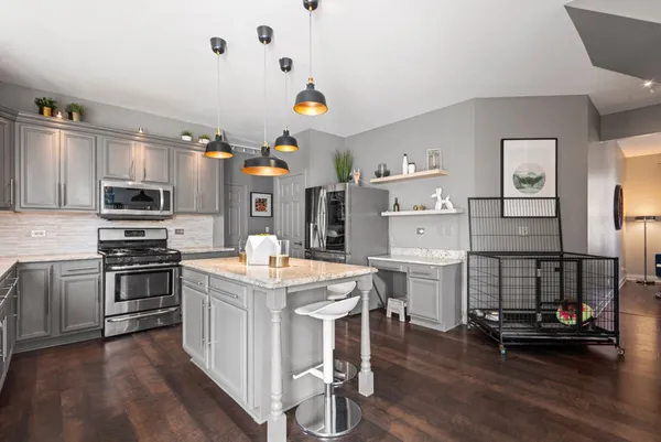 a view of a livingroom with furniture and a kitchen