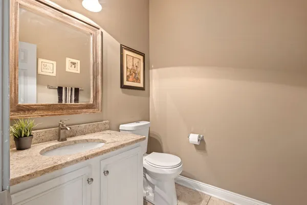 a bathroom with a shower sink mirror and toilet