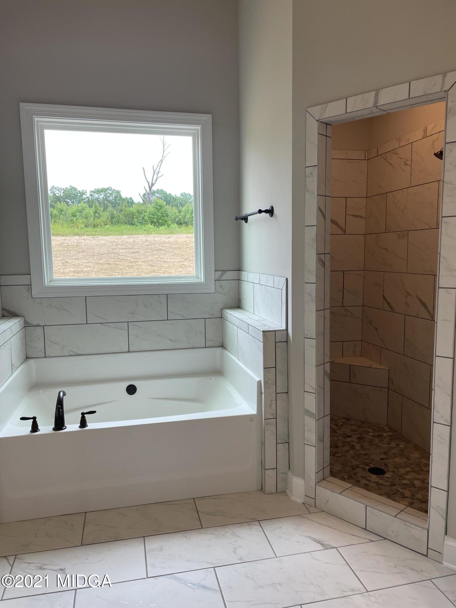 1256 Bunn Road Forsyth, GA 31029 - Photo 10 of 12 a bathroom with a bathtub and shower