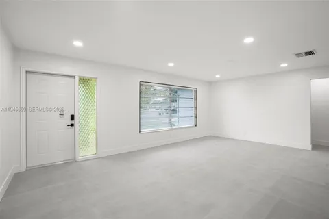 a large white room with lots of wooden cabinets a washer and dryer