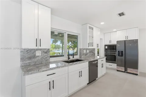 an empty room with a ceiling fan and window