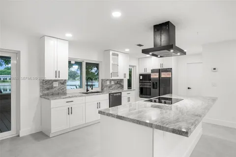 a backyard of a house with lots of green space and lake view