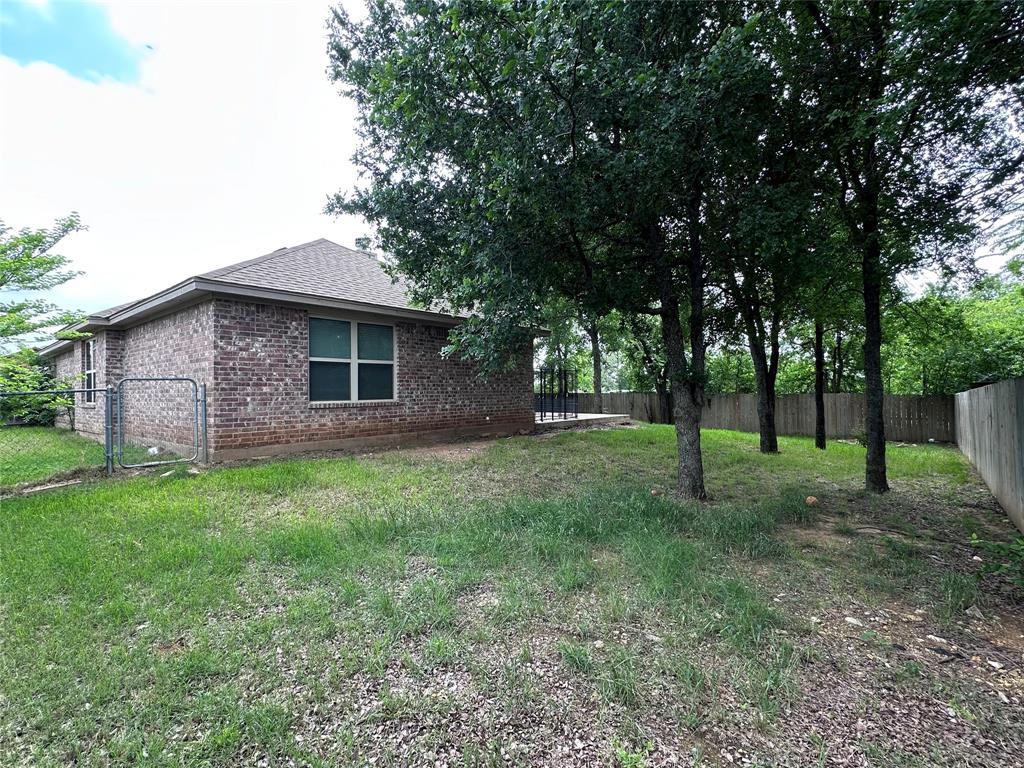 1212 Bowman Ridge Road Stephenville, TX 76401 - Photo 3 of 23 a backyard of a house with lots of green space