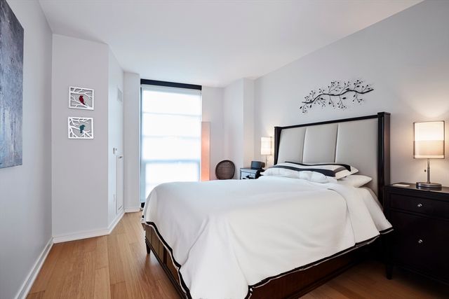 a bedroom with a large bed and a window