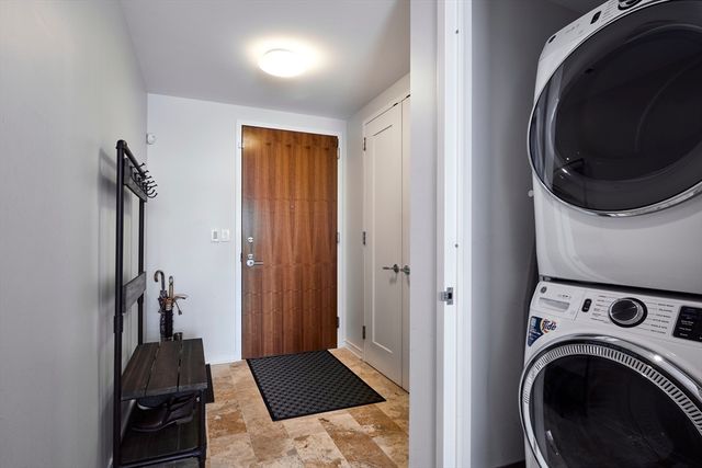 a view of a hallway with washer and dryer