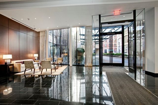 a lobby with furniture and floor to ceiling window