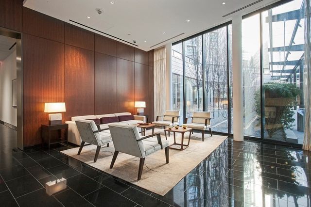 a dining room with furniture and large windows