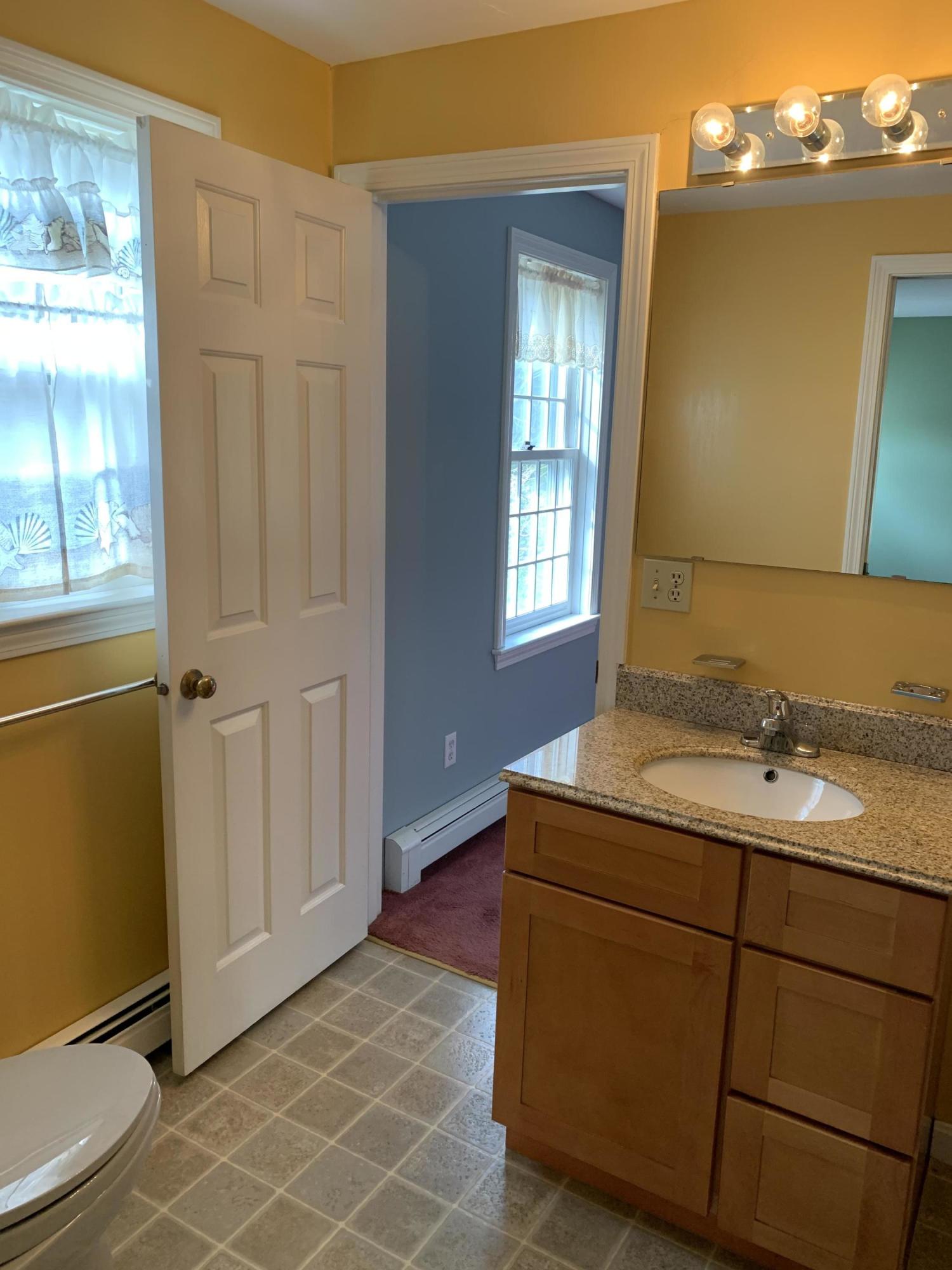9 Hyde Park Centerville, MA 02632 - Photo 19 of 27 a bathroom with a granite countertop sink and a mirror